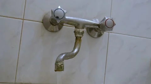 Old, worn out, leaking water tap covered with deposits of limescale and fungi Stock Footage 218174896