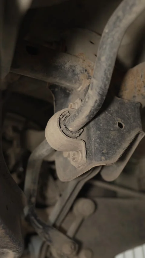 An old worn stabilizer bar bushing is mounted on a car. Stock Footage 341332098