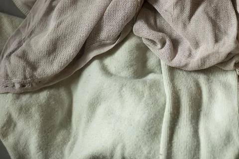 Old worn textiles from clothes in washed out colors. Recycle principle Stock Photos