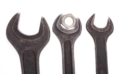 Old wrenches and nut closeup isolated on white background Stock Photos