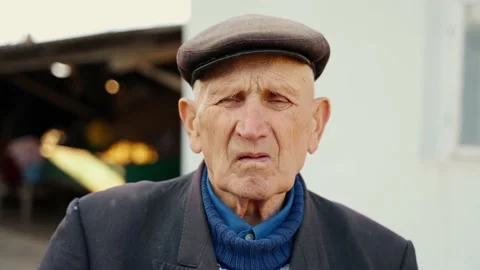 Old wrinkled face of an elderly man looking at the camera close-up. Stock Footage 226868264