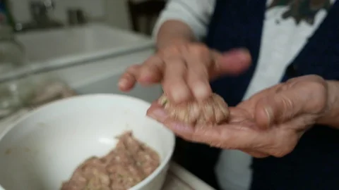 Old Wrinkled Hands Preparing Hamburger Patties in Home Kitchen Stock Footage 99660655