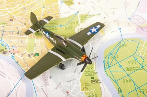 Old WWII model plane over city map Stock Photos