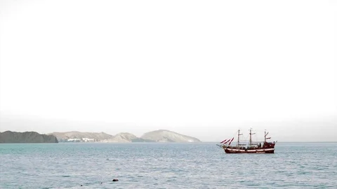 The old yacht with three masts and scarlet sails goes by the sea Stock Footage