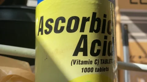 Old yellow Ascorbic Acid Vitamin C tablets bottle close up view indoor Stock Footage 249371912