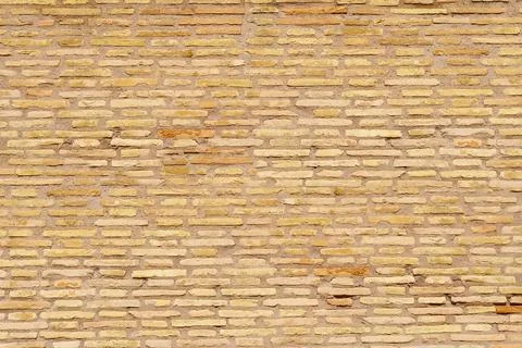 Old yellow brick wall on the background of blue sky Stock-Fotos