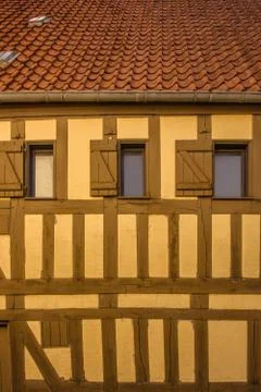 Old yellow building with windows Stock Photos