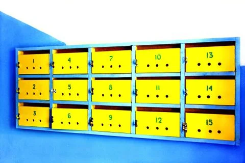 Old yellow mailboxes on a wall. Stock Photos