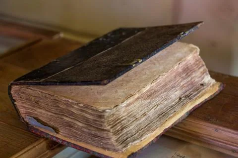 Old yellow manuscript on the table. Aged antique book sheets. Stained history Stock Photos