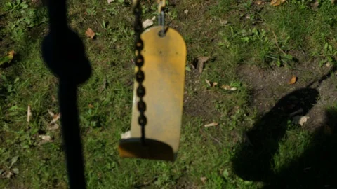 Old yellow swing top view with shadows gentle breeze blowing with child climb Stock Footage 95032253