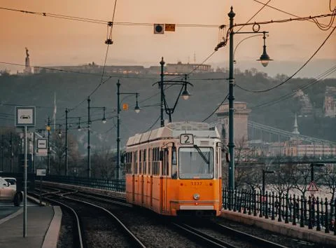 An old yellow tram on the Danube River embankment. Stock Photos