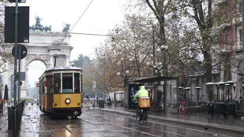 Old yellow tram passes by the centre of the Old Town of Milan Arch of Peace 動画素材 165844419