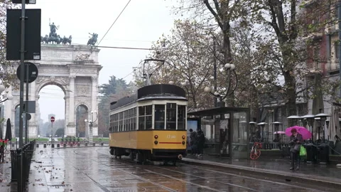 Old yellow tram passes by the centre of the Old Town of Milan Arch of Peace 動画素材 165847617