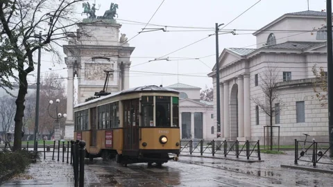 Old yellow tram passes by the centre of the Old Town of Milan Arch of Peace Stock-Footage 165849179