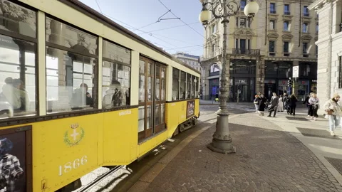 Old yellow tram passes by the centre of the Old Town of Milan. Stock Footage 263024462