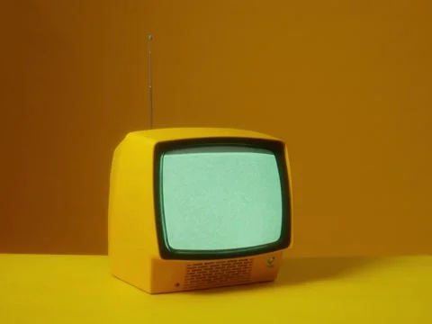 Old yellow TV with noises on the screen on a yellow background Stock Footage 229767867