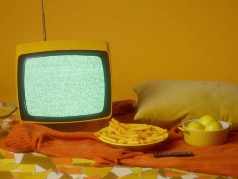 Old yellow TV with noises on the screen on a yellow background Stock Footage 229767875