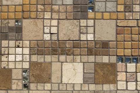 Old yellow wall with square ceramic tiles of different sizes and shades. roug Foto stock