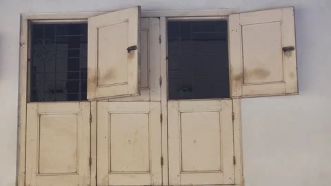 Old yellow wooden window open on white wall Stock Footage 306847723