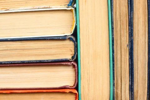 Old yellowed books in a stack in the background Stock Photos