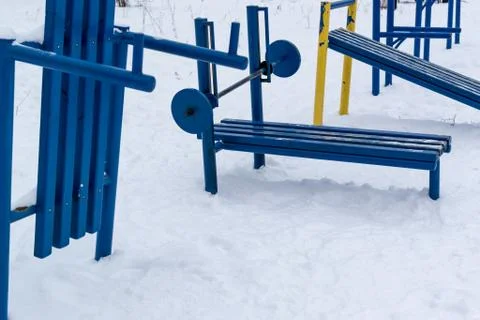 Old yet still functional soviet style outdoor gym painted in blue paint with  Stock Photos