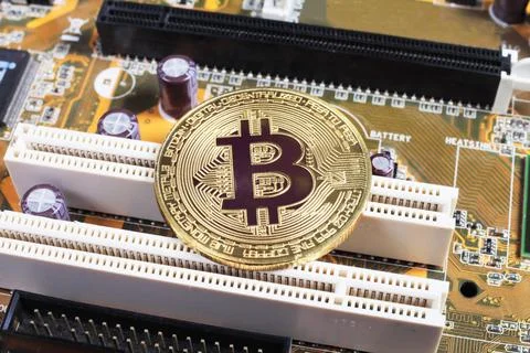 Olden bitcoin on a computer board, close-up, Stock Photos