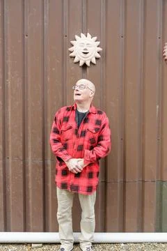 Older bald man with surprised expression on face, mouth open looking upwards Stock Photos
