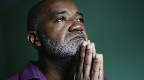 An older Brazilian man praying to God Stock Photos