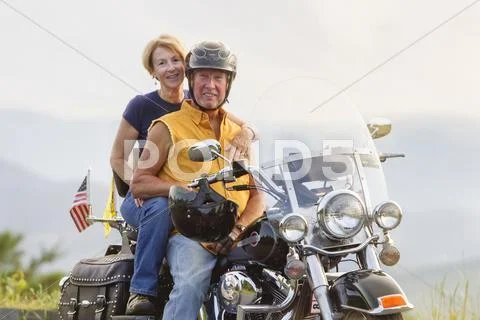 Older Caucasian Couple Smiling On Motorcycle