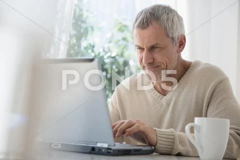 Older Caucasian Man Using Laptop