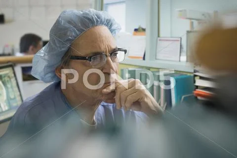 Older Caucasian Surgeon Thinking In Office