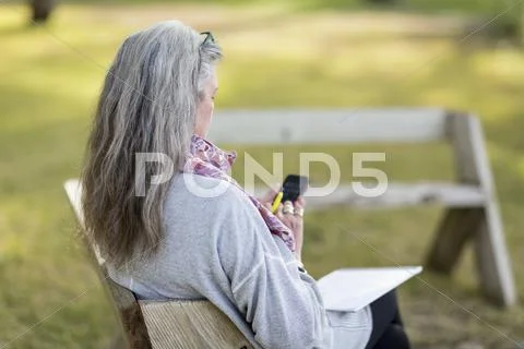 Older Caucasian Woman Using Cell Phone Outdoors