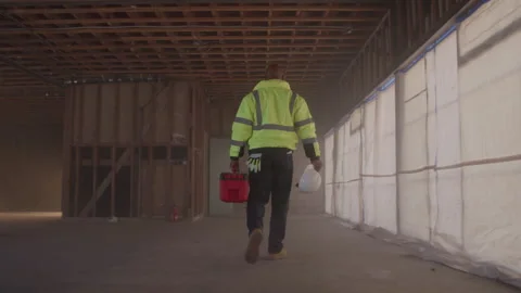 Older Construction Worker Carries Toolbox On Job Site Stock-Footage 270390148