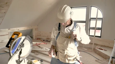 Older construction worker with hard hat applies I voted sticker smiles winks Stock Footage 81800459