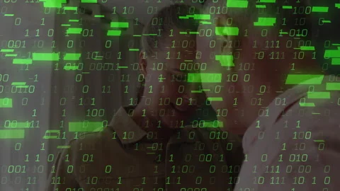 Older couple leaning close in lounge, initiating animated binary code showcasing Stock Footage 310153853