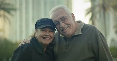 Older couple looking at camera and smiling at park in Florida Stock Footage 234530538