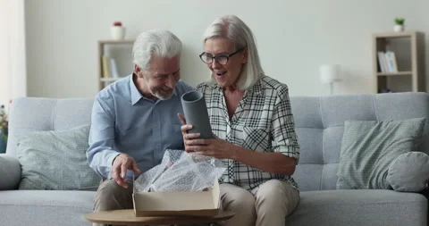 Older couple open parcel box with new bought vase 動画素材 239866886