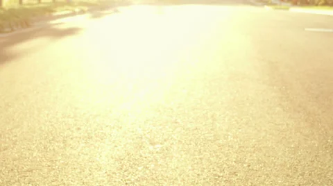 An older couple rides bikes down the street at sunset as the camera follows them Vidéo 33863486