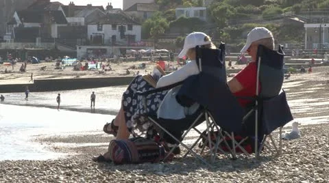 Older Couple Sat on Beach Stock Footage 18010085