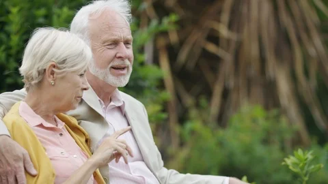 An older couple sat on a bench talking Stock Footage 91519342