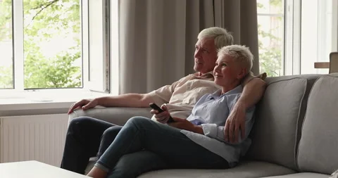 Older couple switch channels, choose favourite program relaxing at home Video stock 170242203