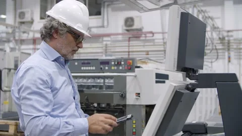 Older factory engineer testing industrial machine Stock Footage 147499756