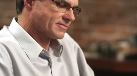 An older gentleman works on a computer pad Stock Footage 33885179