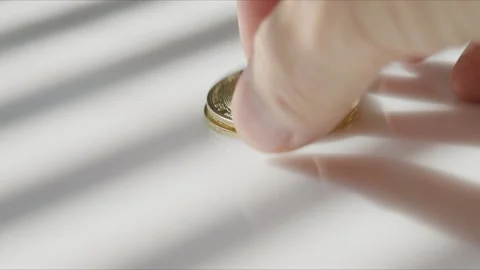 Older Hand Placing Bitcoin Stack on White Desk Under Blind Shadows Stock Footage 346380439