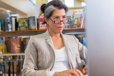 Older Hispanic woman using computer in library 写真素材