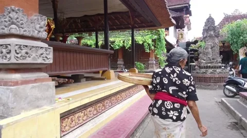 Older Local Lady preparing the Temple in Bali, Indonesia Stock Footage 131154256