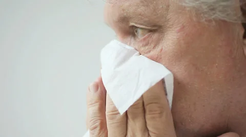 Older man blows his nose Stock Footage 28255486