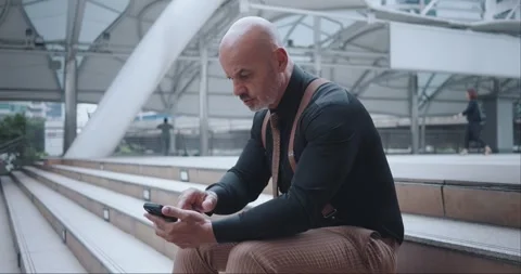 Older man classical suit mobile phone frustration sadness hand to face business Stock Footage 274394409