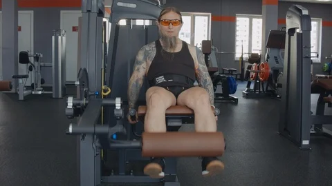 An older man does leg extension Stock Footage 115430945