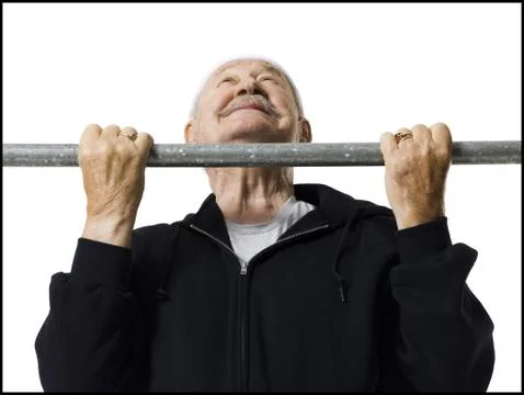 Older man doing chin up exercises Stock Photos